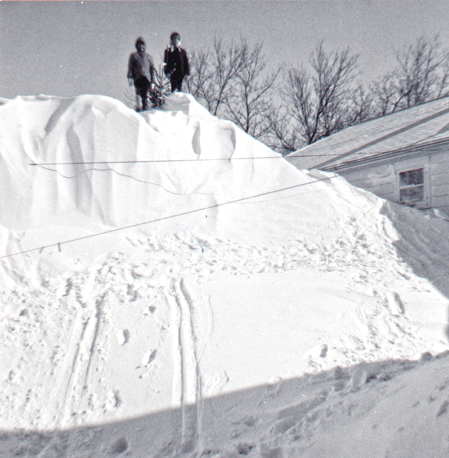 two girls on a snow pile