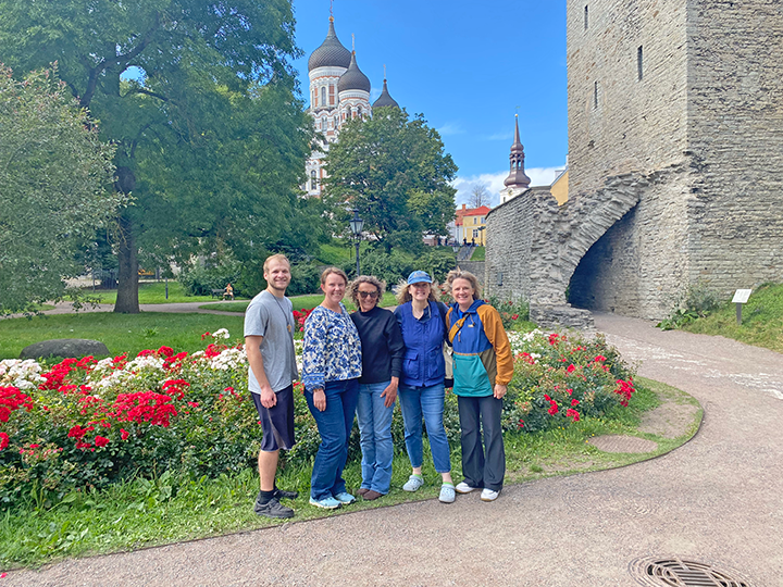 people posing in front of old buildings.