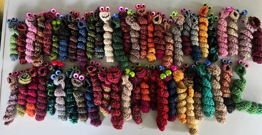 Crocheted worry worms with puppet eyes.